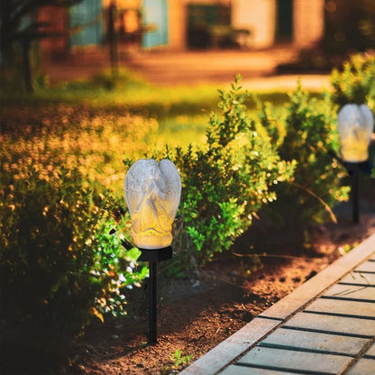 Belro Solar Angel Garden Light illuminating a garden at dusk with a decorative angel design and solar-powered lighting.