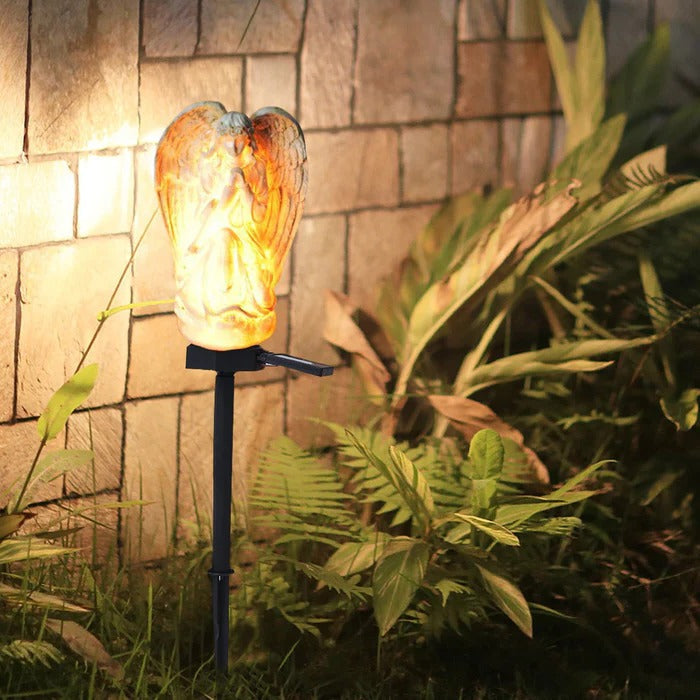 Belro Solar Angel Garden Light illuminating a garden with a decorative angel design for outdoor night lighting.