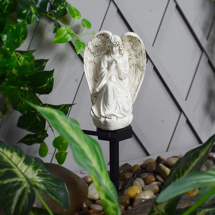 Belro Solar Angel Garden Light emitting a soft glow in a garden setting, designed for outdoor decorative lighting.