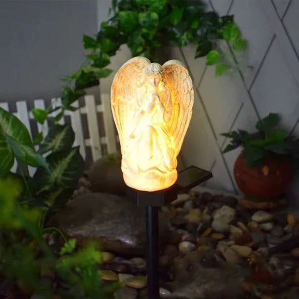 Belro Solar Angel Garden Light emitting a soft glow, perfect for outdoor nighttime garden illumination.