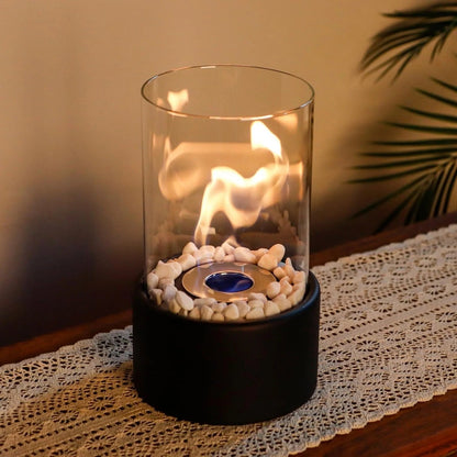 Belro portable glass tabletop fireplace for outdoor use, showcasing a sleek design with clear glass panels and a burning flame.