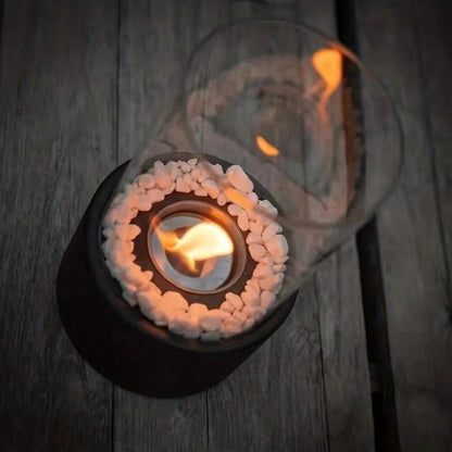 Belro portable glass tabletop fireplace for outdoor use, featuring sleek design and clear glass with a visible flame.