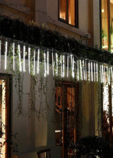 Belro LED Dripping Icicle Lights hanging outdoors, creating a festive, shimmering display for home and garden decor.
