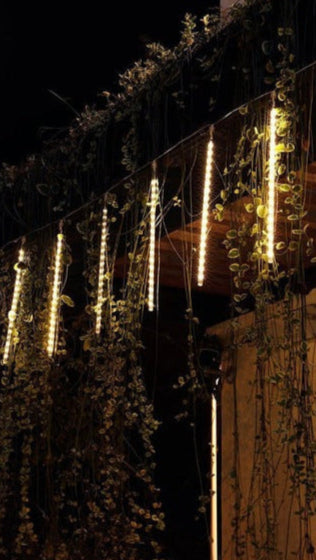 Belro LED Dripping Icicle Lights hanging outdoors, decorative string lights for home and garden outdoor use.