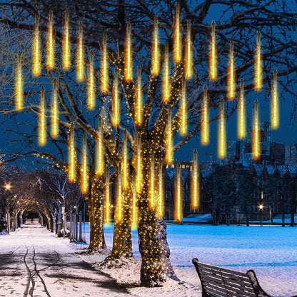 Belro LED dripping icicle lights hanging outdoors, illuminating a garden for festive or decorative outdoor lighting.