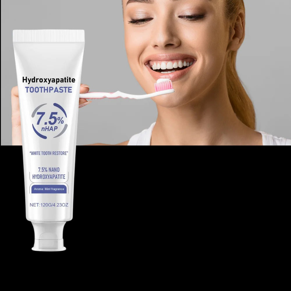 Belro fluoride-free enamel toothpaste tube with mint flavor, shown with fresh mint leaves in the background.