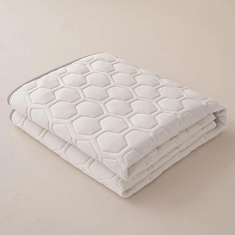 Belro cooling mattress pad on a bed, designed to enhance sleep comfort with breathable, cooling fabric for hot nights.