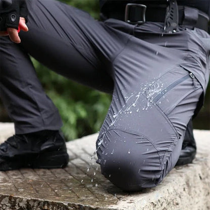 Men’s Belro waterproof winter cargo trousers shown in dark color, featuring multiple pockets and a durable, insulated design for cold weather.
