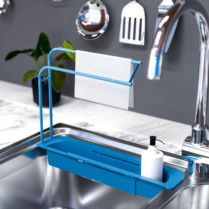 Belro expandable sink organizer in a kitchen, showing multiple compartments for utensils and cleaning supplies.