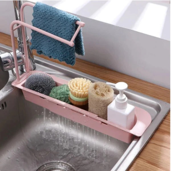 Belro expandable sink organizer in a kitchen setting, with compartments for utensils and cleaning supplies.