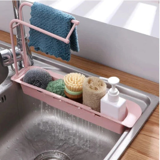 Belro expandable sink organizer in a kitchen setting, with compartments for utensils and cleaning supplies.