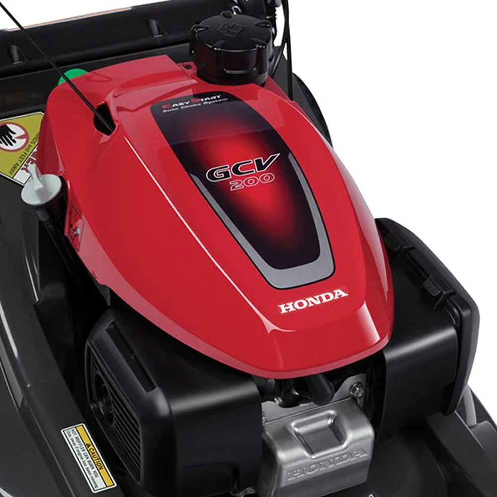 Honda HRX217VKA 21-inch gas self-propelled lawn mower with 200cc engine, shown in a yard setting.