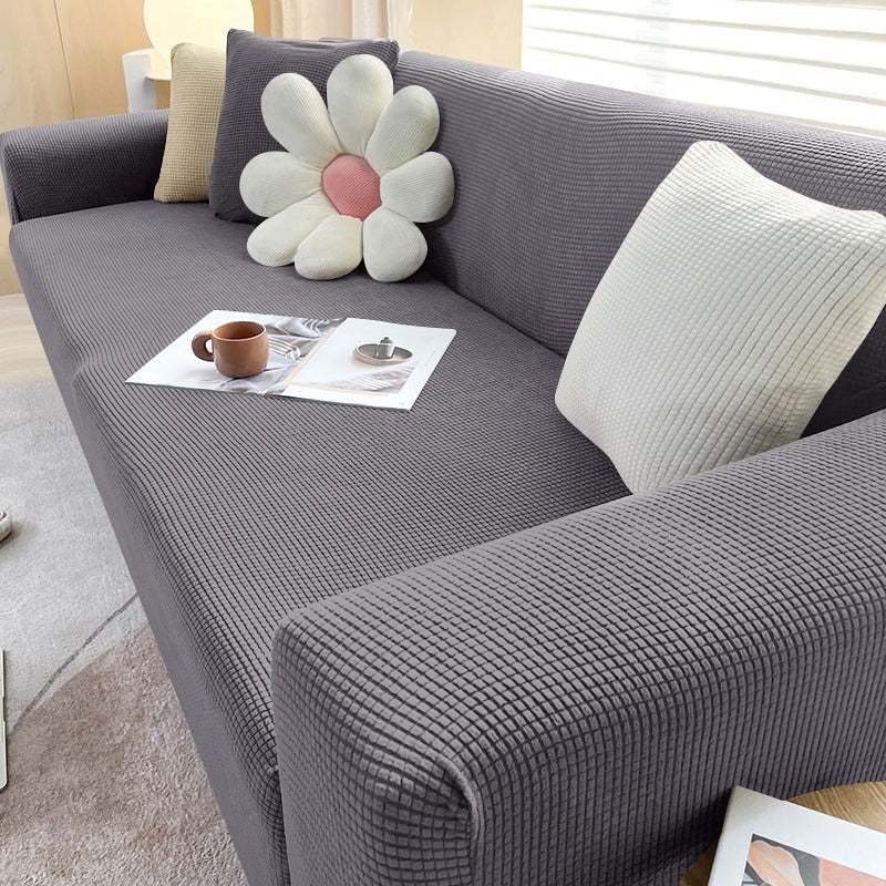 Belro stretchable sofa cover fitted on a modern couch, protecting and transforming furniture in a stylish home setting.