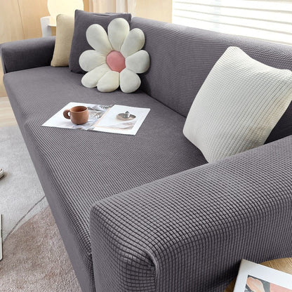 Belro stretchable sofa cover fitted on a modern couch, protecting and transforming furniture in a stylish home setting.