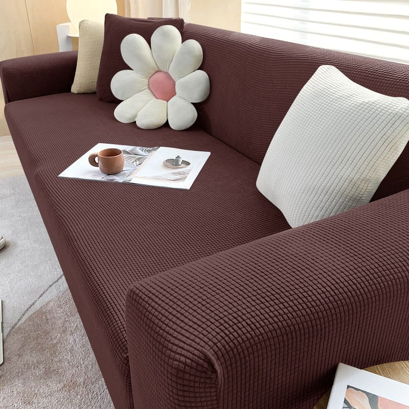 Stretchable sofa cover by Belro, fitting a standard sofa with a smooth, snug fit in a modern home decor setting.
