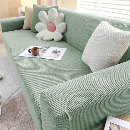 Stretchable Belro sofa cover fitted on a modern sofa, designed to protect and enhance home furniture with a snug fit.