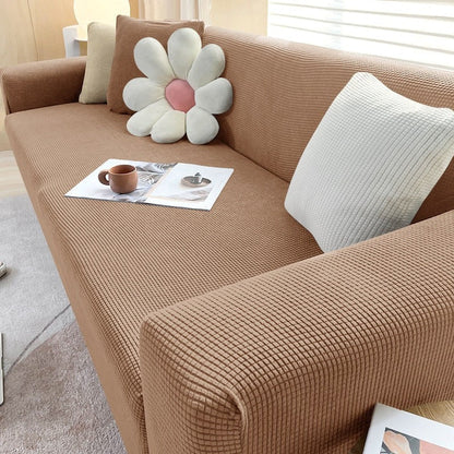 Stretchable Belro sofa cover fitting a modern living room sofa, made from elastic fabric for easy fitting and protection.