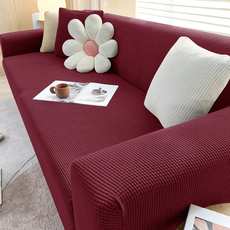 Belro stretchable sofa cover in a neutral color, fitted over a modern sofa, showcasing its elastic design and snug fit.