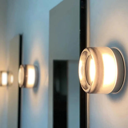Modern dimple glass LED wall sconce by Belro, outdoor lighting fixture with sleek design and illuminated glass shade for home exterior.