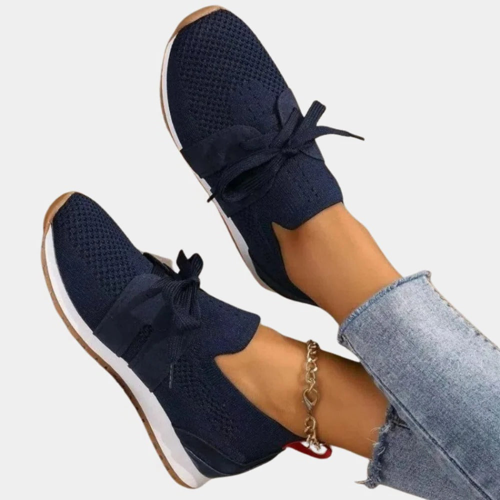 Belro women's stylish sneakers in white with pink accents, featuring a comfortable athletic design and lace-up closure.