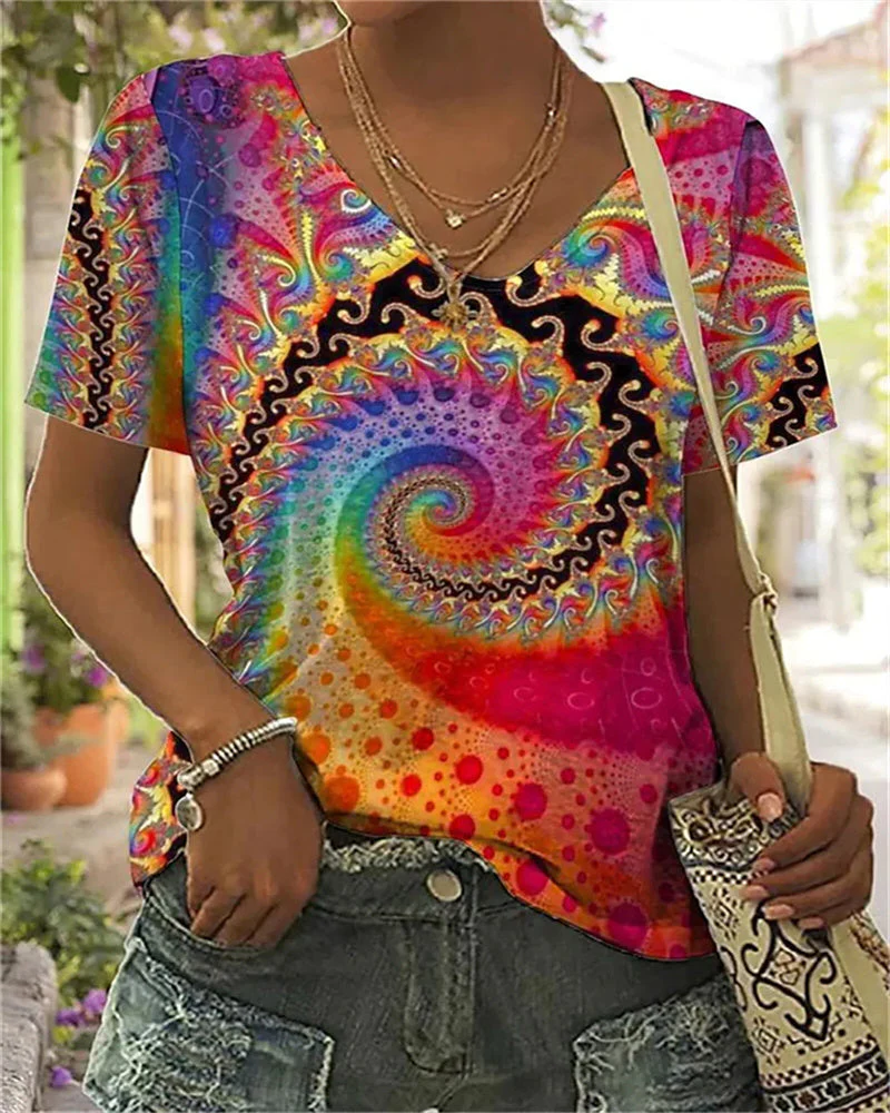 Women's colorful Belro shirt with vibrant patterns and long sleeves, displayed flat on a neutral background.