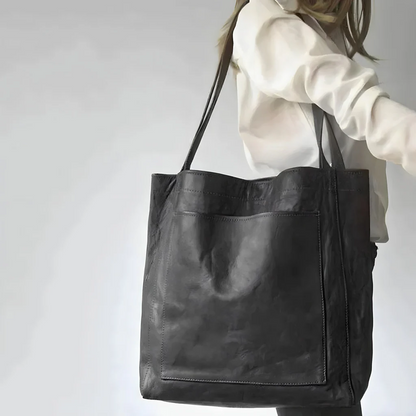 Belro women's leather bag with sleek design, showing smooth leather surface and elegant wallet-style accessory.