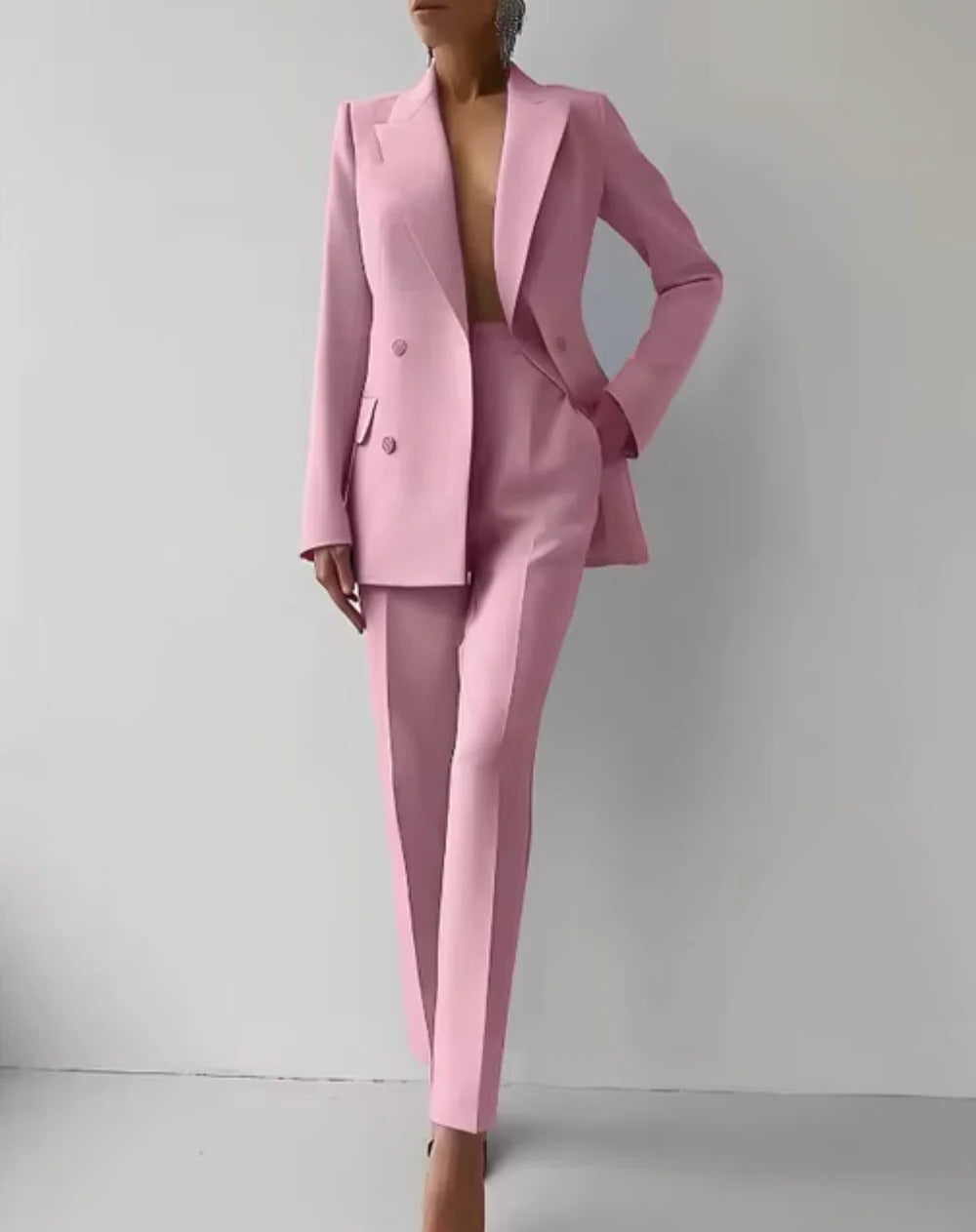 Women's classic Belro suit with lapel blazer and high-waisted pants, shown in a professional indoor setting.
