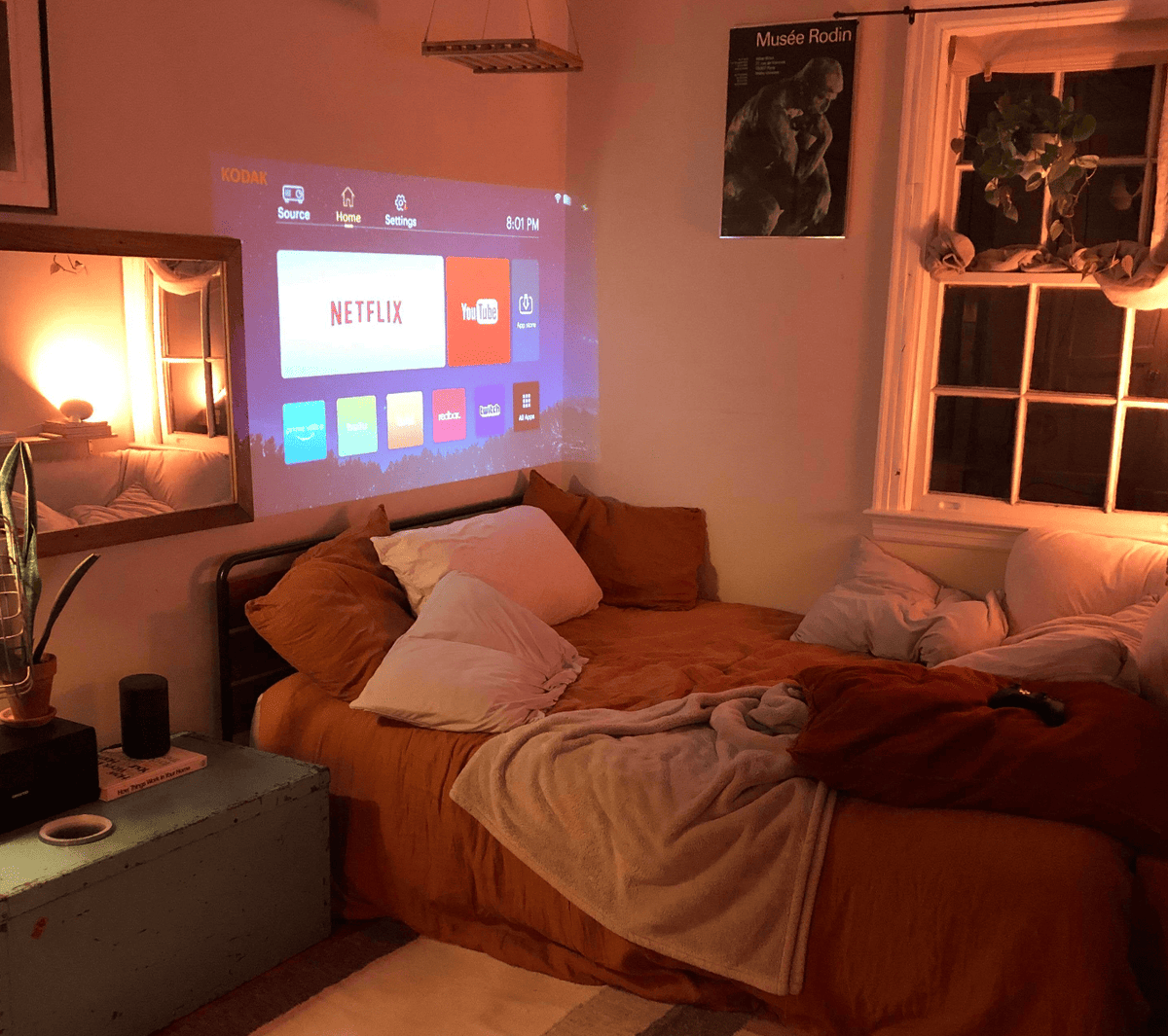 Belro Mini Movie Projector displaying a colorful image on a wall, compact electronic device for home entertainment.