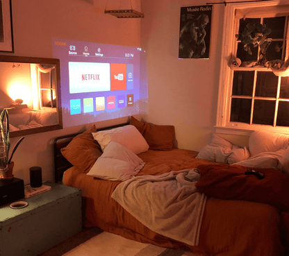 Belro Mini Movie Projector displaying a colorful image on a wall, compact electronic device for home entertainment.