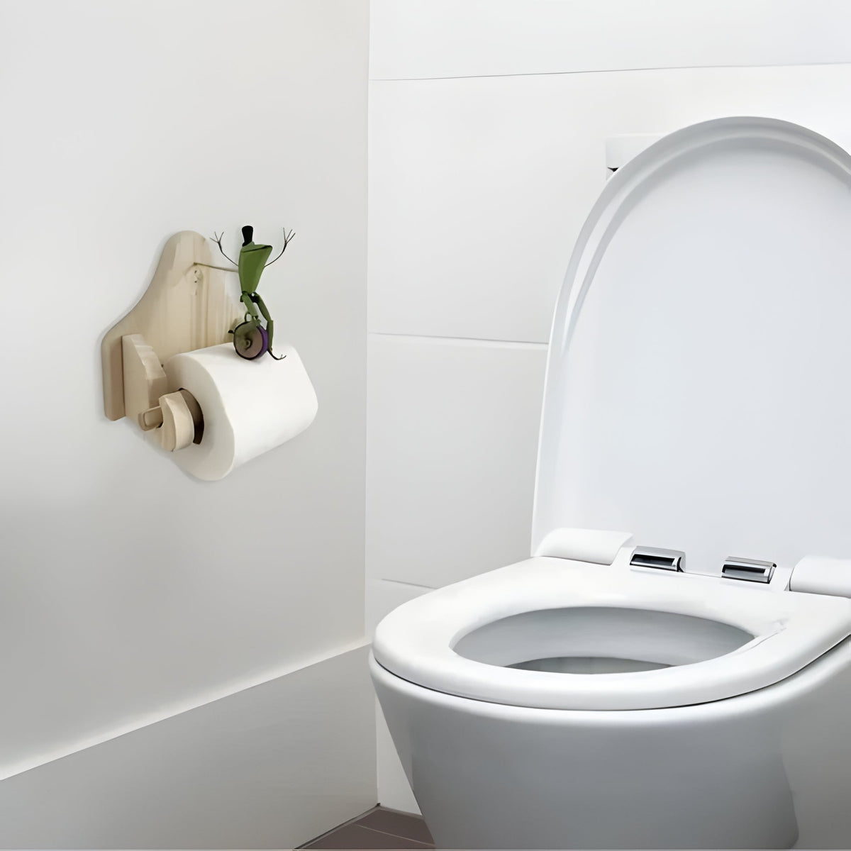 Belro Frog Rider toilet paper holder mounted outdoors, decorative metal holder with frog design for garden or patio use.