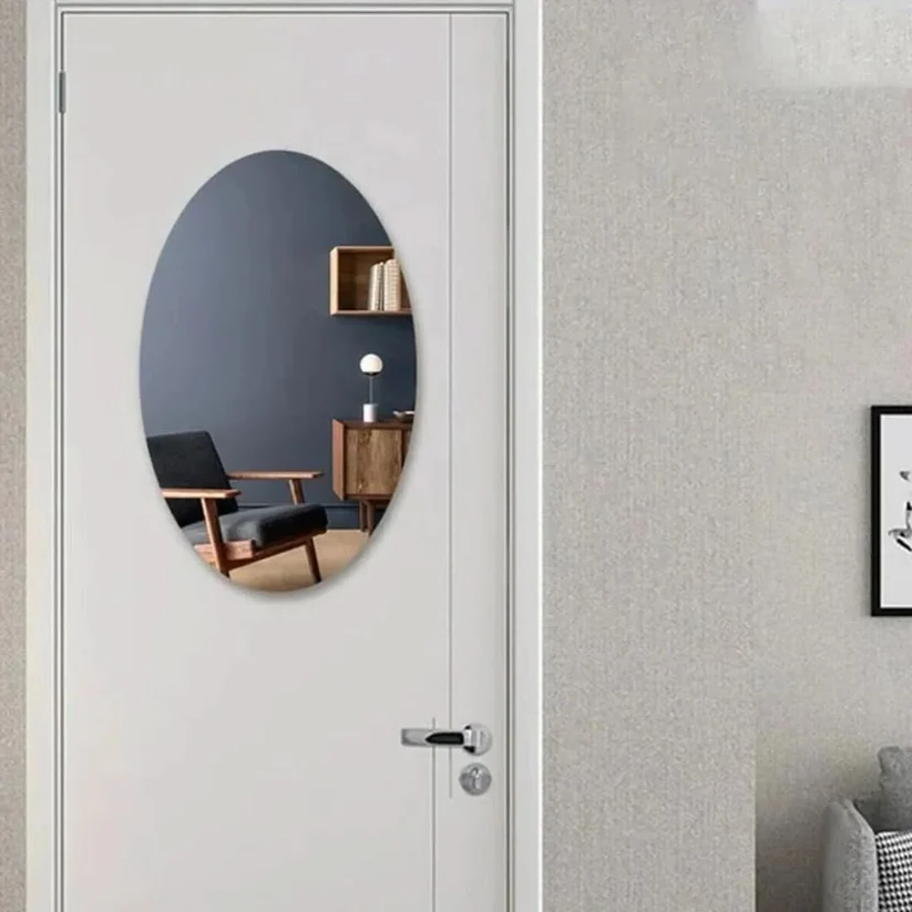 Oval-shaped Belro adhesive mirror mounted on a wall, showcasing its sleek, reflective surface and easy-to-apply design.