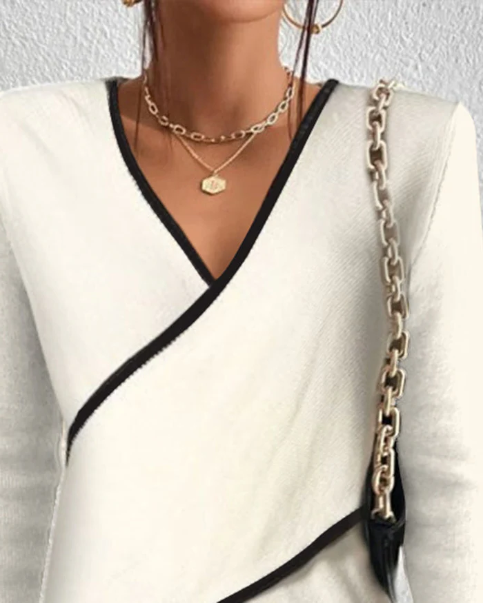 Ivory V-neck sweater by Belro featuring a soft knit fabric and classic fit, displayed on a hanger.
