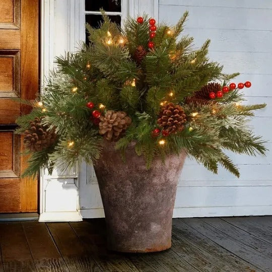 Pre-lit artificial Christmas tree by Belro with realistic branches and an urn filler for holiday home decor.