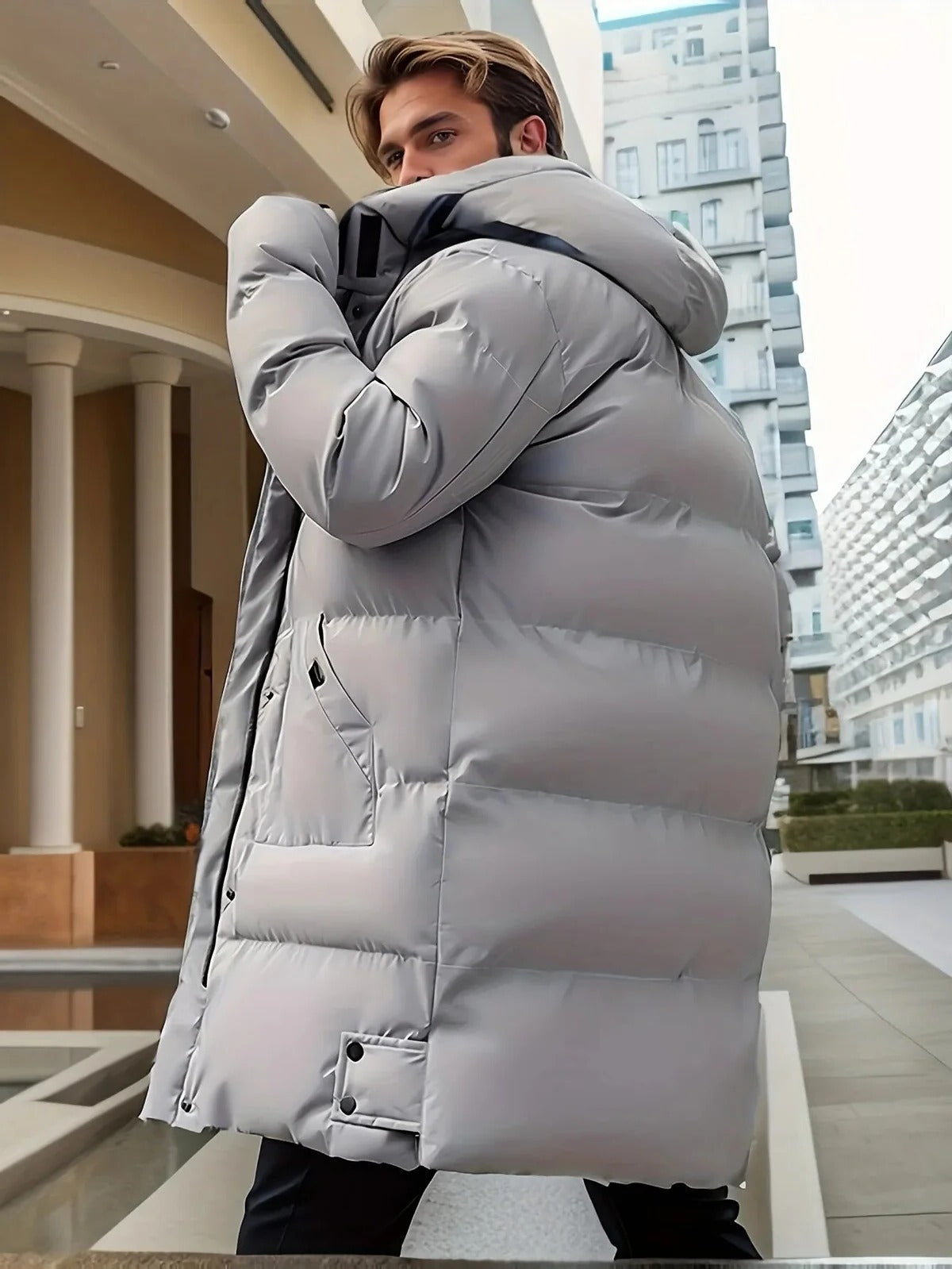 Men's Belro long winter jacket, waterproof and warm, with a hood, front zipper, and insulated design for cold weather protection.