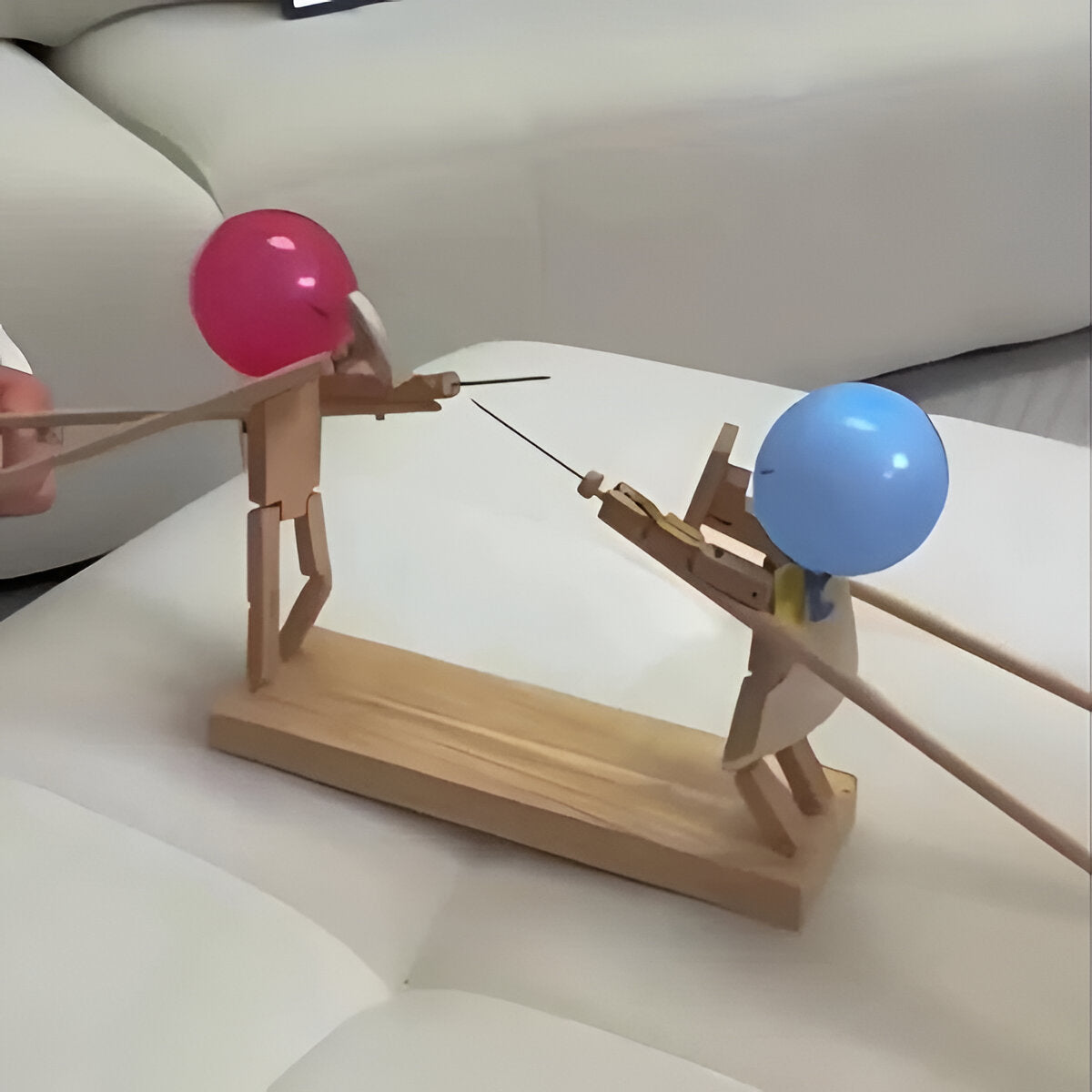 Wooden fencing puppets game by Belro, featuring colorful puppet characters on a wooden playset for children's fun and imaginative play.
