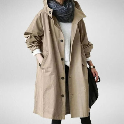 Women's long waterproof raincoat by Belro, shown in a stylish rain jacket design with a hood and waterproof fabric.