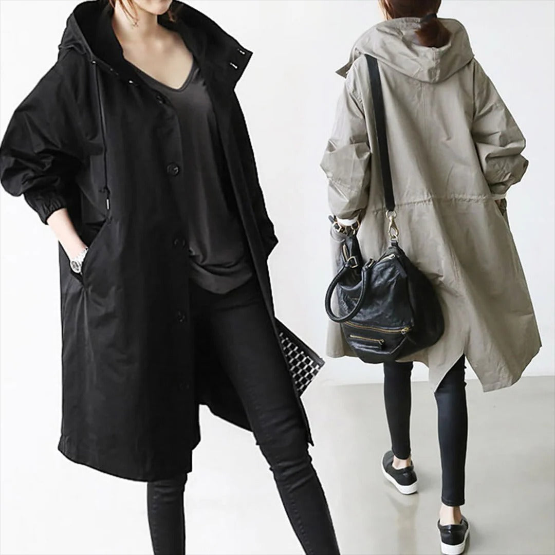 Belro women's long waterproof raincoat hanging outdoors, lightweight and rain-resistant for wet weather protection.