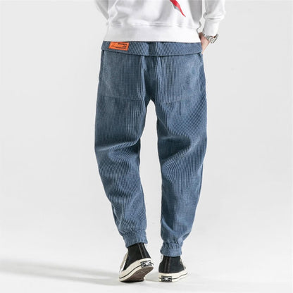 Belro corduroy trousers featuring a classic ribbed texture and tailored fit, shown in a neutral color.