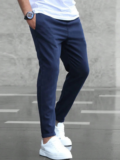 Men's Belro stretch pants in navy, showing a slim fit design with elastic waistband and side pockets.