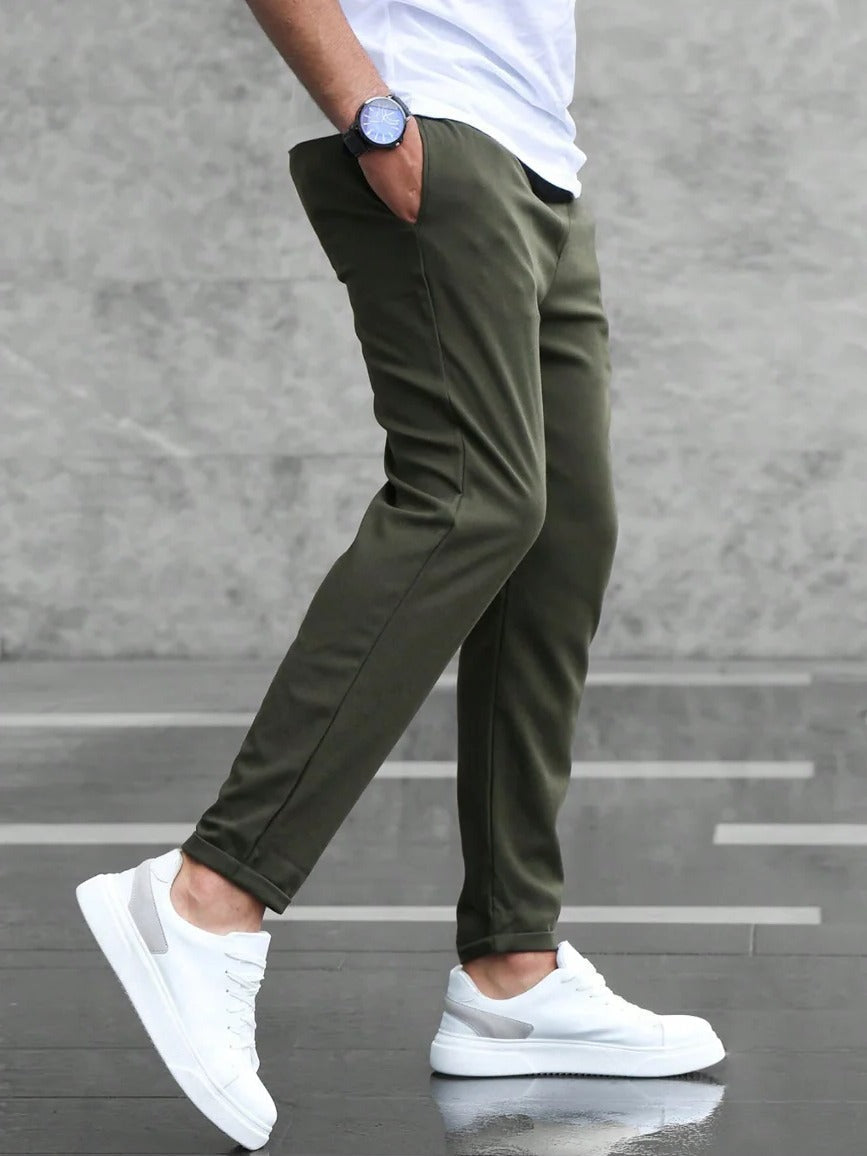 Men's Belro stretch pants with a slim fit, showing the front view in dark fabric with belt loops and classic trouser details.