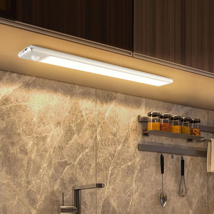 Belro magnetic motion sensor light mounted on a wall, showcasing its sleek electronic design and magnetic attachment feature.