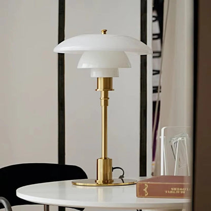 Belro Scandinavian LED table lamp on a desk, modern design, energy-efficient lighting for home or office use.