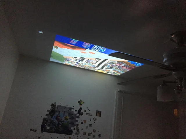 Belro mini movie projector displaying a colorful image on a wall, compact electronic device for home entertainment.