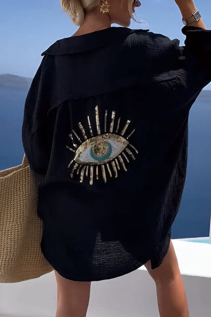 Belro evil eye shirt with sequin bead details, stylish clothing featuring vibrant blue and silver accents on fabric.
