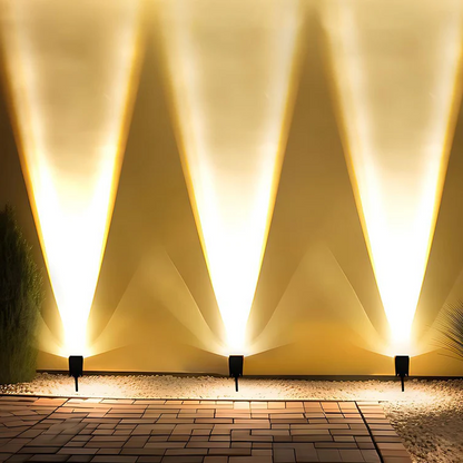 Belro waterproof LED solar multi-zoom spot light for outdoor landscape lighting with RGB color options, shown illuminating a garden area.