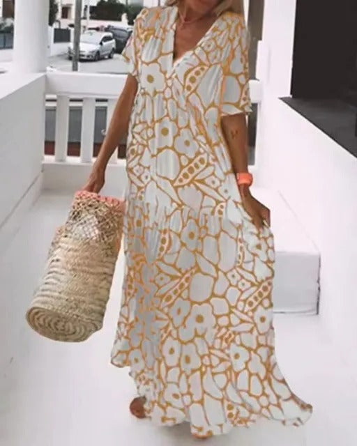 Belro long dress with short sleeves featuring a colorful print, flowing fabric, and stylish design for casual or semi-formal wear.