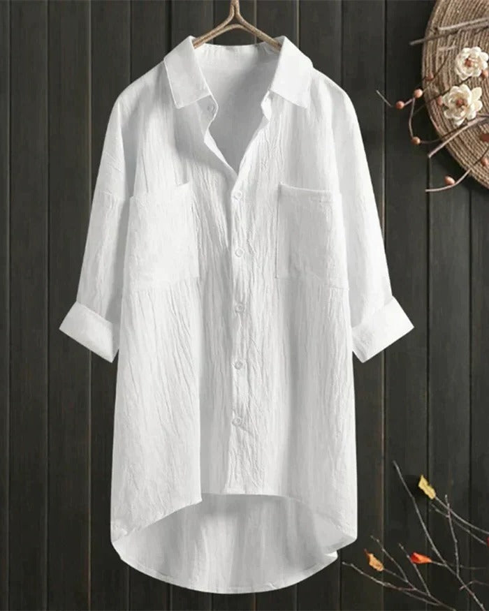 Women's white linen blouse by Belro, featuring lightweight fabric, relaxed fit, and classic design, shown on a hanger.