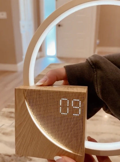 Belro Sunrise Simulation Alarm Clock displaying a bright, sunrise-like light with digital time on a bedroom bedside table.