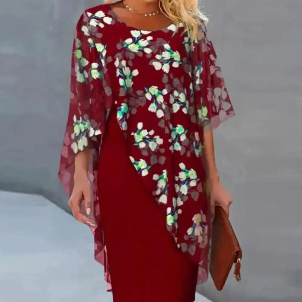 Elegant floral dress for women by Belro, featuring a flowy design with colorful flower patterns and a fitted waist.