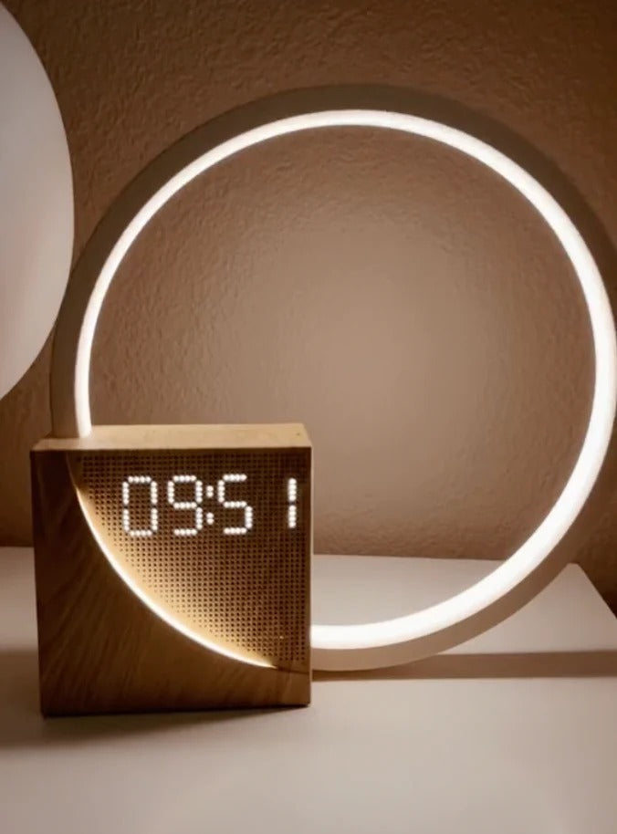 Belro Sunrise Simulation Alarm Clock displaying a bright, sunrise-like light with digital time on a bedroom nightstand.